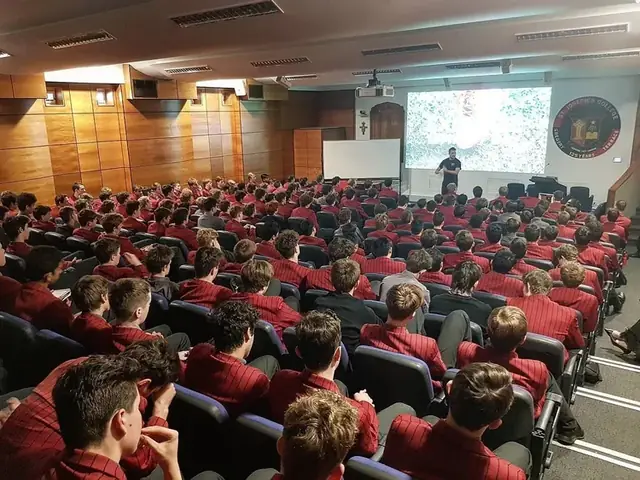 A full auditorium during a Simple Six presentation