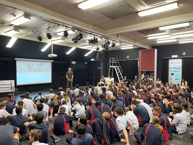Students in a school theatre for the Simple Six